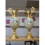 A fine pair of ceramic and gilded ewers, 66 cm tall. Collect Only.