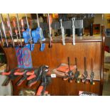 Three shelves of clamps etc.,