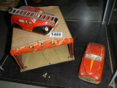 A Mettoy tinplate Joytown fire station and two fire engines.
