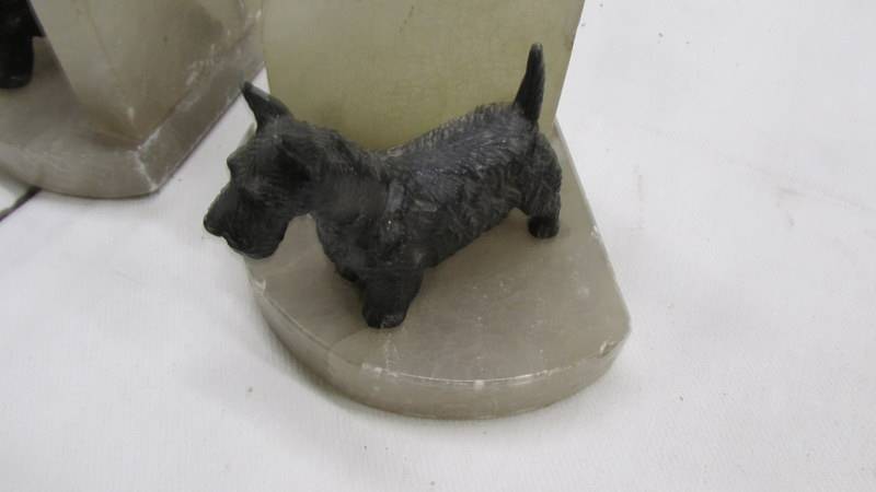 A pair of 1930's spelter and onyx bookends surmounted Scottie dogs. - Image 2 of 2