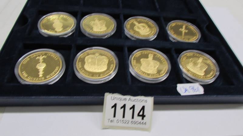 Eight 'The Crown Jewels' gold plated coins.