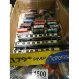 A quantity of 'N' gauge model railway coaches, rolling stock and vehicles.