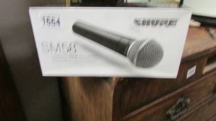 A boxed SM58 vocal microphone.