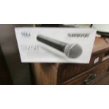 A boxed SM58 vocal microphone.