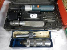 A boxed Black & Decker hand drill and one other item.