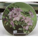 A floral decorated ceramic plaque, 36 cm diameter.