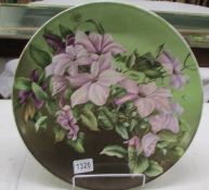 A floral decorated ceramic plaque, 36 cm diameter.