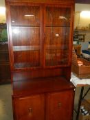 A 20th century mahogany glazed door dresser.