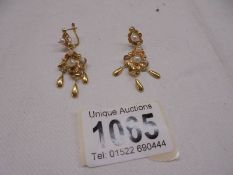 A pair of 18ct gold pendant earrings set pearls, total weight 4 grams.