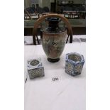 A Chinese vase and two blue and white candleholders.