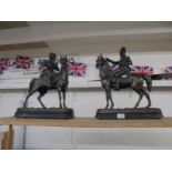 A pair of bronze knight's on horse back.