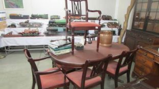 An oval mahogany dining table and six chairs. COLLECT ONLY.