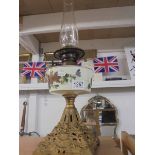 A Victorian oil lamp on metal base with hand painted font and complete with chimney.