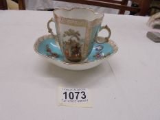 A continental porcelain hand painted two handled tea cup with saucer.