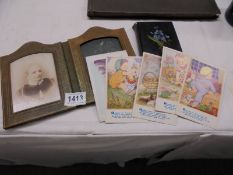 A Victorian photograph album, a folding frame and a quantity of Phyllis M Purser postcards.
