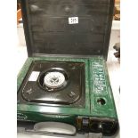 A cased camping stove.