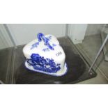 A blue and white Ironstone triangle shaped cheese dish.