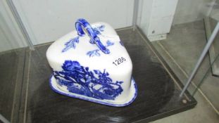 A blue and white Ironstone triangle shaped cheese dish.