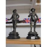 A pair of metal cavalier figures.