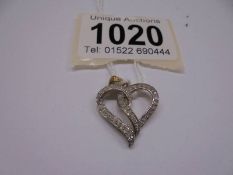 A yellow gold double heart diamond pendant, 1.8 grams.