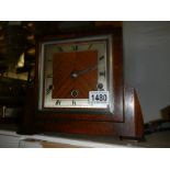 A 1930's oak mantel clock with three key holes.