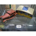 A pre/post ware clockwork tinplate car with caravan, (caravan missing a wheel.)