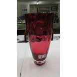 A heavy cranberry glass vase. 28 cm tall.