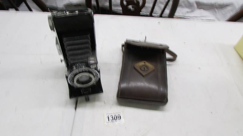 A vintage Agfa folding camera in leather case.