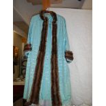 A lady's blue gown with fur trim.