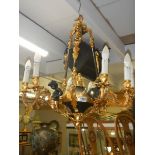 A Victorian Adam style brass and glass chandelier surmounted with cherubs. COLLECT ONLY.