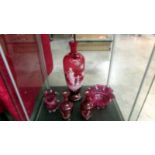 A Cranberry glass 'Mary Gregory' style vase, a similar smaller pair and a cranberry glass sugar bowl