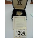 A cased 2000 silver proof £1 England coin with certificate.