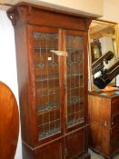 An art nouveau lead glazed oak book case. COLLECT ONLY.