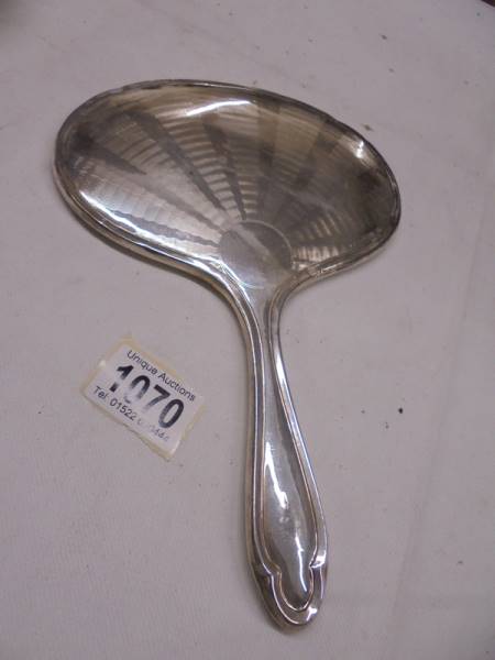 A silver backed hand mirror.