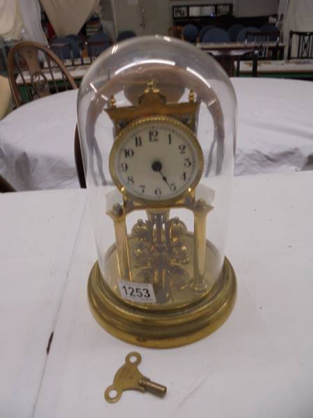 A 1905 400 day Torsion clock by Jaurensuren Fabric under glass dome.