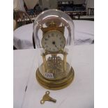 A 1905 400 day Torsion clock by Jaurensuren Fabric under glass dome.