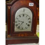 A Victorian mahogany inlaid chiming mantel clock in working order.