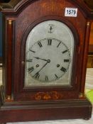 A Victorian mahogany inlaid chiming mantel clock in working order.