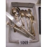 14 silver teaspoons (170 grams) a silver handled knife and a silver handled fork.