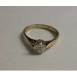 A diamond single stone ring, London hall mark, yellow gold shank, size M.