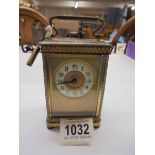 A brass carriage clock with key.