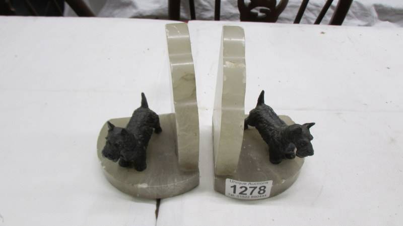A pair of 1930's spelter and onyx bookends surmounted Scottie dogs.