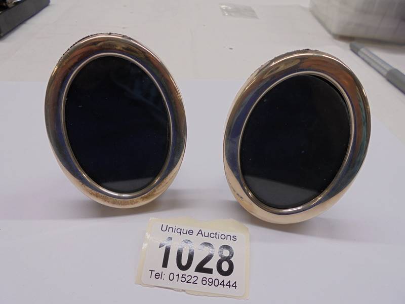 Two small oval silver photo frames.