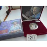 A cased 'The Queen Mother' 1900-2000 silver centenary crown with certificate.