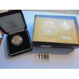 A cased 2002 Gold proof sovereign with certificate.
