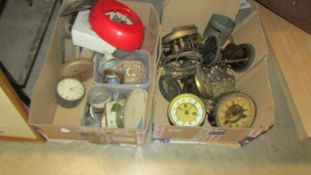 Two boxes of old clock parts.
