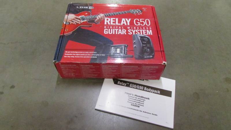 A boxed relay G50 digital wireless guitar system with instructions.