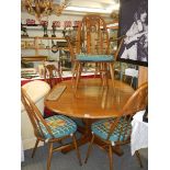 An Ercol dining table and six chairs. COLLECT ONLY.