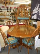 An Ercol dining table and six chairs. COLLECT ONLY.