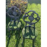 A cast iron garden table with two chairs. Collect Only.